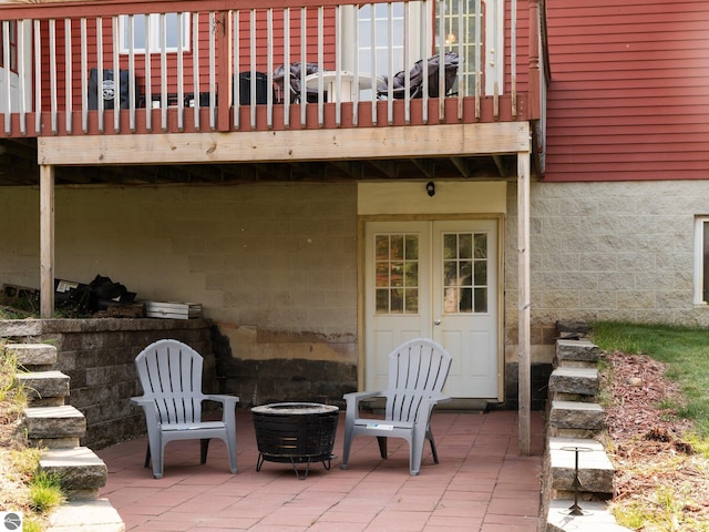 view of patio / terrace featuring a wooden deck and a fire pit