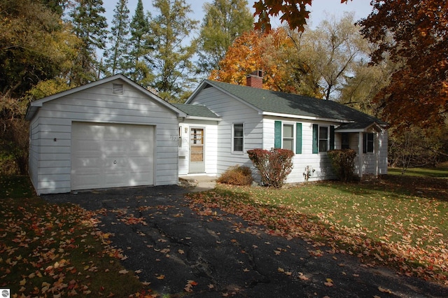 ranch-style home with a front lawn and a garage