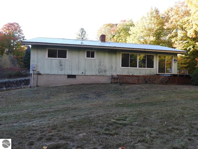 rear view of property featuring a yard