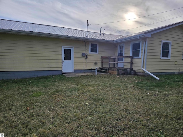 back of house with a lawn