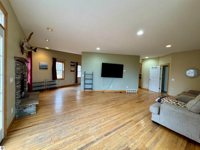 unfurnished living room with light hardwood / wood-style flooring and a fireplace