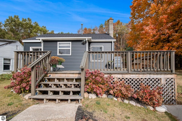 rear view of property with a wooden deck