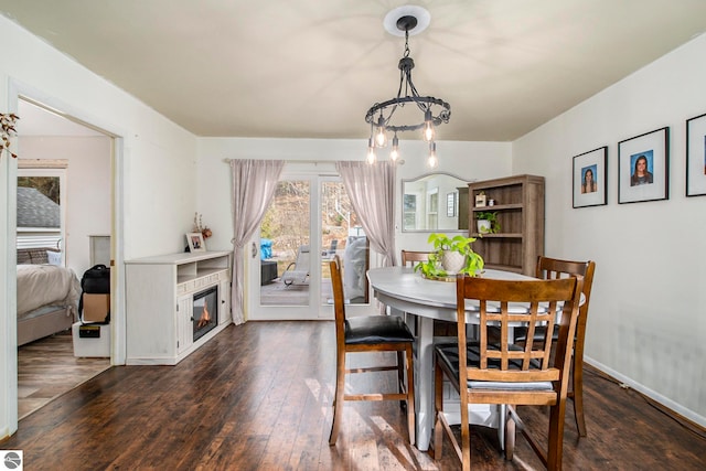 dining room featuring dark hardwood / wood-style flooring and a chandelier