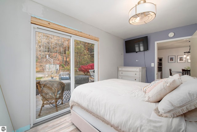 bedroom featuring light hardwood / wood-style floors and access to outside