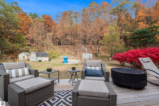 wooden deck featuring a storage unit and outdoor lounge area