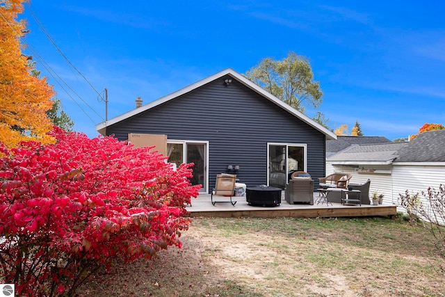 rear view of house with a yard and a wooden deck