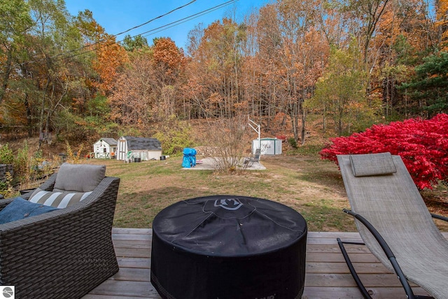 deck with a yard and a storage shed