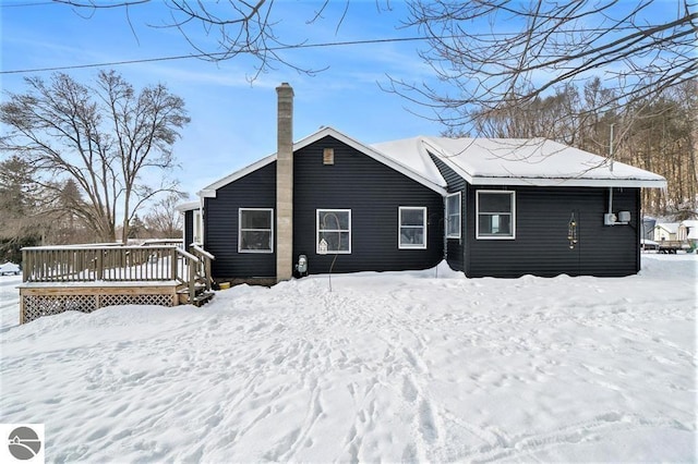 1219 Elm St, Frankfort, MI 49635 - snow covered property featuring a chimney and a deck