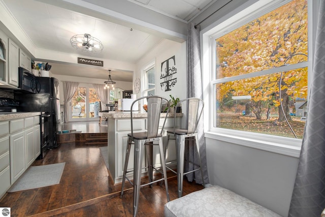 dining room featuring a chandelier, crown molding, and dark hardwood / wood-style flooring