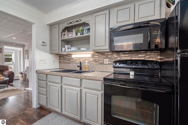 kitchen with sink, gray cabinetry, black appliances, and crown molding