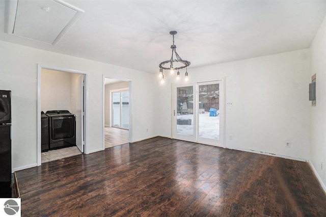 1219 Elm St, Frankfort, MI 49635 - unfurnished living room with washing machine and clothes dryer, baseboards, and wood finished floors