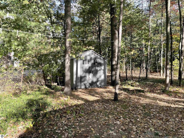 view of shed with a forest view