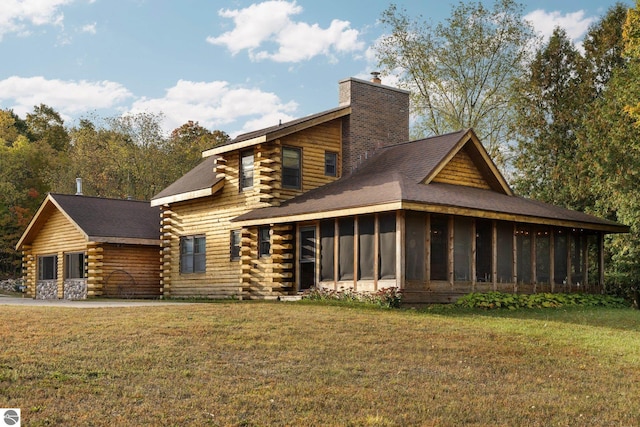 back of property featuring a yard and a sunroom