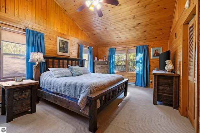 carpeted bedroom with multiple windows, wood walls, wood ceiling, and ceiling fan