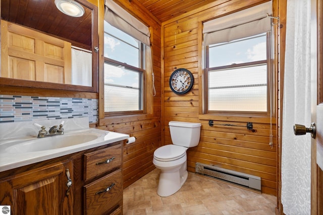 bathroom with toilet, wooden walls, a baseboard heating unit, wooden ceiling, and vanity