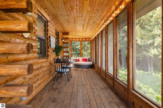 unfurnished sunroom featuring wood ceiling and vaulted ceiling