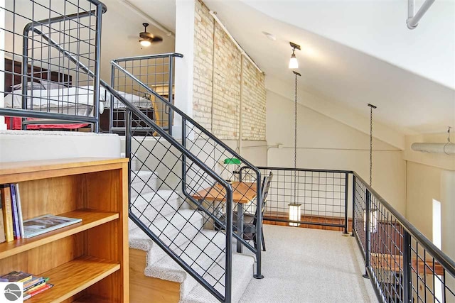 staircase with hardwood / wood-style floors and ceiling fan