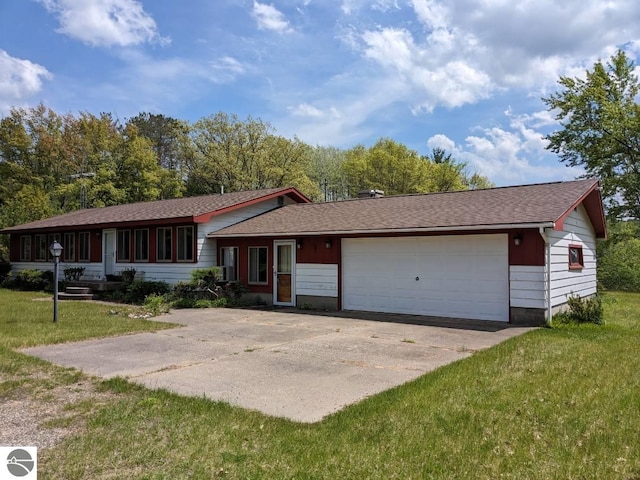 view of front of home featuring a garage, roof with shingles, and a front yard