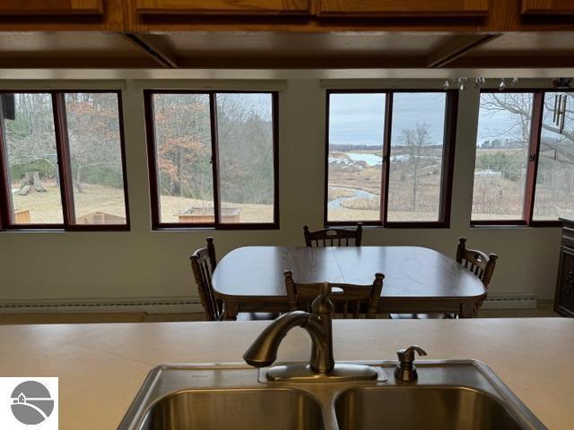 dining space with a wealth of natural light and beam ceiling