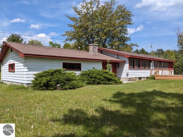 view of front of home featuring a chimney and a front yard