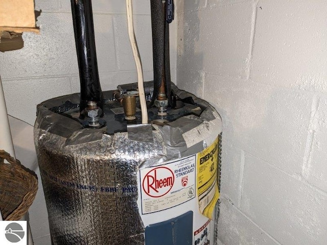 interior details with electric water heater and concrete block wall