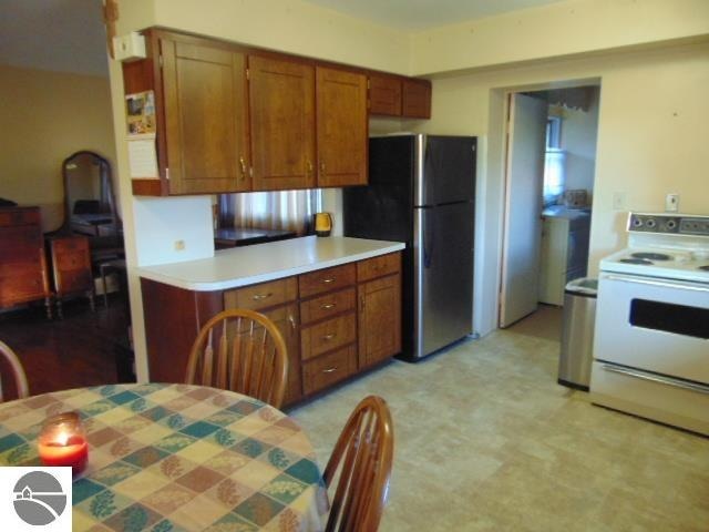 kitchen with stainless steel refrigerator and white electric stove