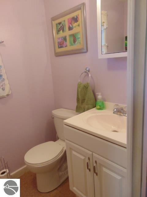 bathroom with vanity, toilet, and tile patterned flooring