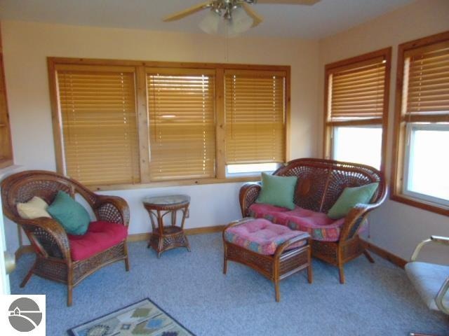 sitting room featuring carpet and ceiling fan