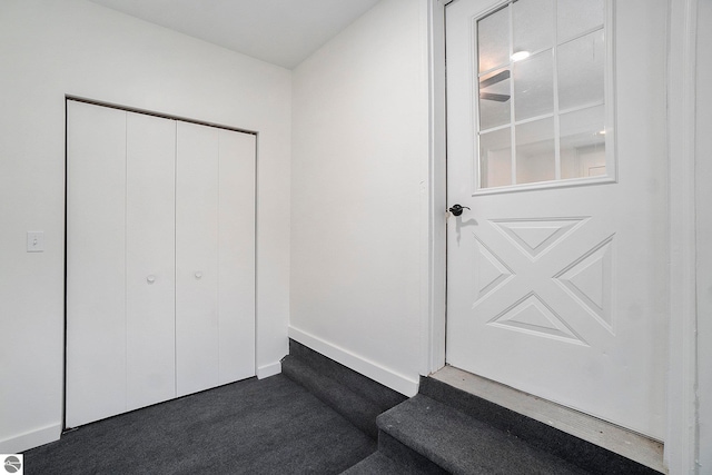 interior space with a closet and dark colored carpet