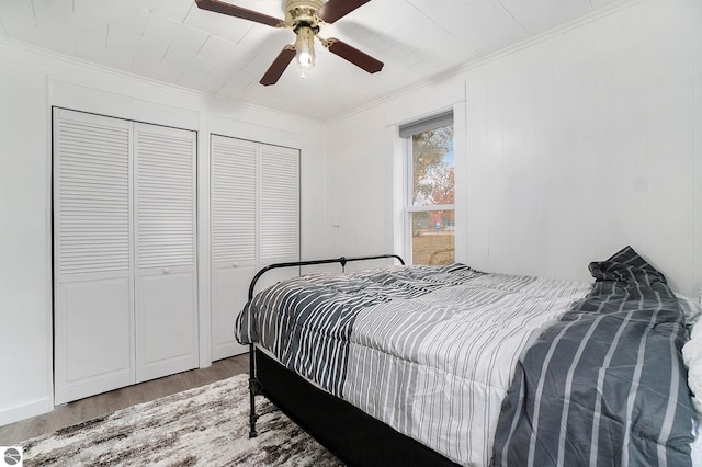 bedroom with a ceiling fan, wood finished floors, and crown molding