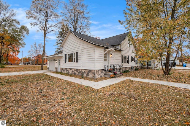 view of side of home featuring an attached garage and concrete driveway
