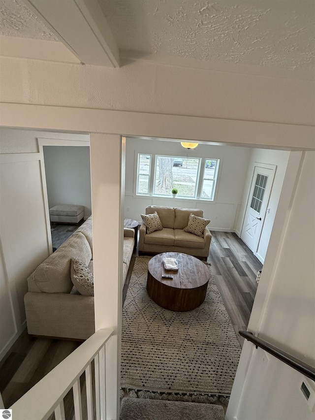 living area with wood finished floors and a textured ceiling