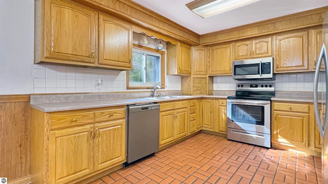 kitchen with backsplash, stainless steel appliances, and sink