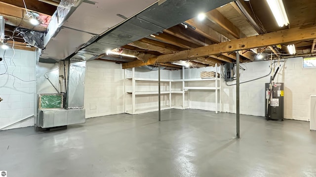 basement featuring electric panel, heating unit, water heater, and washing machine and clothes dryer