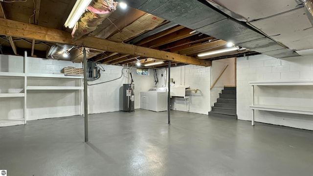 basement featuring water heater, electric panel, and washing machine and dryer