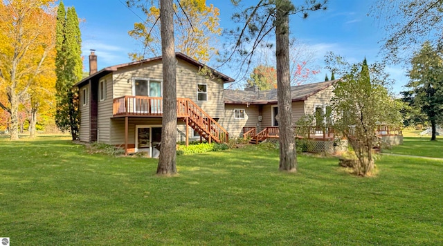 rear view of house featuring a yard and a deck