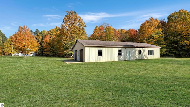 view of outdoor structure with a yard and a garage