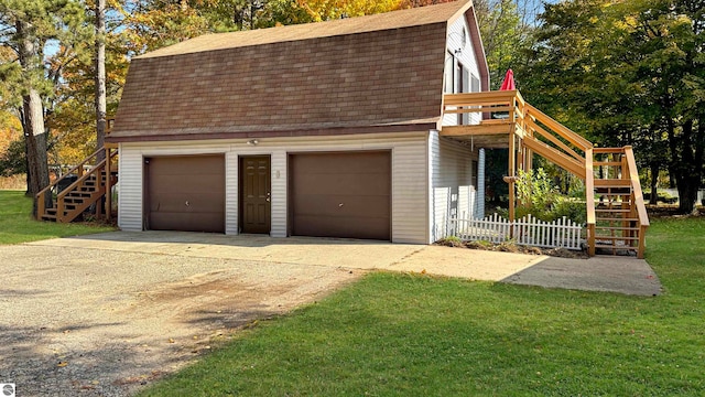 garage featuring a lawn