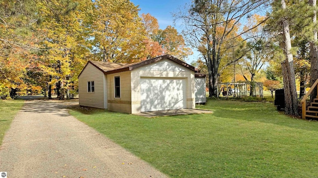 view of outdoor structure with a lawn and a garage