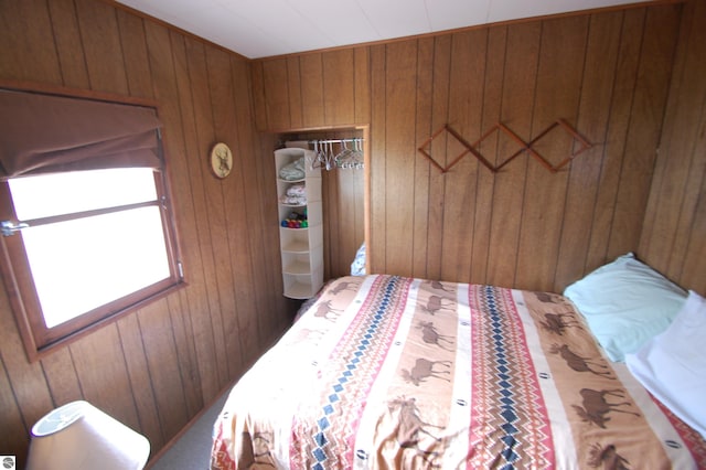 bedroom featuring a closet and wood walls