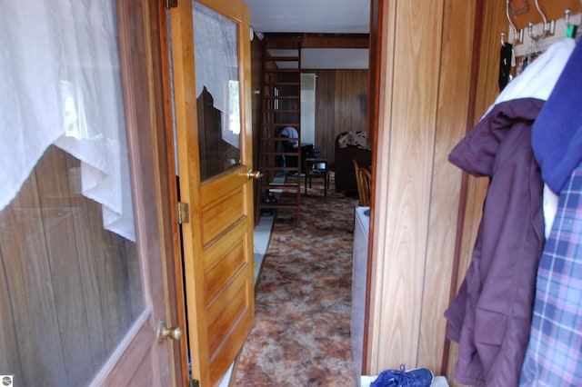 corridor featuring wooden walls