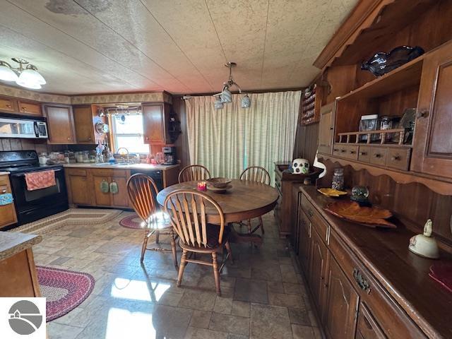 dining room with a textured ceiling and sink