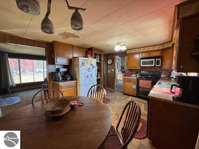 dining room featuring wood walls