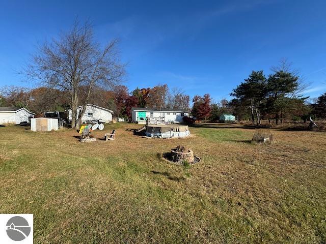 view of yard with a fire pit