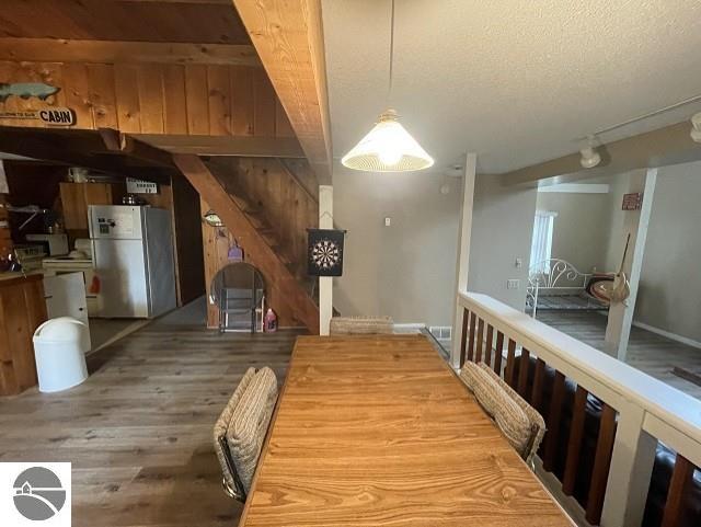 dining area featuring hardwood / wood-style floors and a textured ceiling