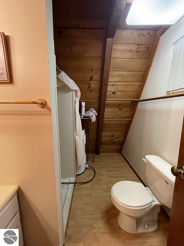 bathroom with vanity, toilet, walk in shower, and wood ceiling