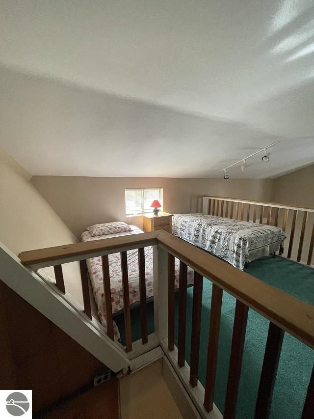 additional living space featuring lofted ceiling