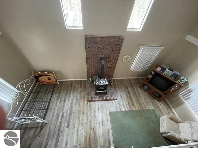 living room with hardwood / wood-style floors and a wood stove