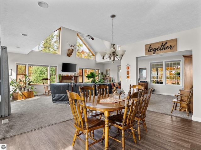 dining area featuring a healthy amount of sunlight, wood-type flooring, and a chandelier