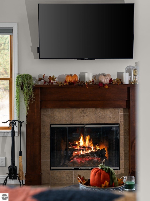 interior details with a tile fireplace